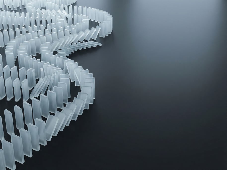 Dominoes mid-topple, thousands of pieces creating a cascading wave pattern across a dark floor (bf1drhop)