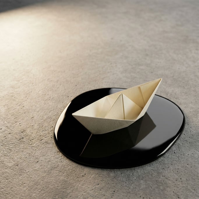A paper boat floating on a small pool of still water on a concrete surface, tiny and contemplative (zpqsakti)