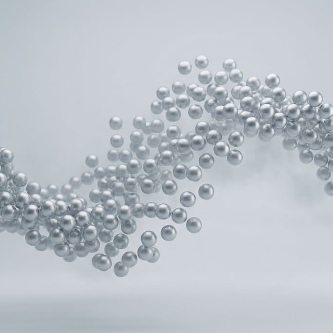 Hundreds of tiny spheres arranged in a wave formation, particle simulation frozen mid-flow