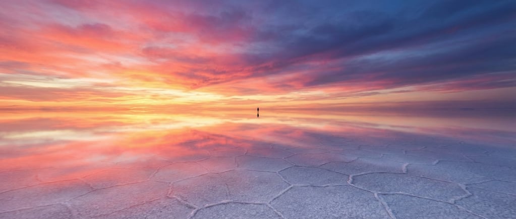 Panoramic 3D sunset salt flats — a vast perfectly flat expanse of white salt crust reflecting a spec