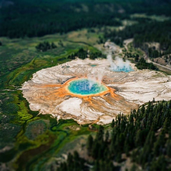 Volcanic hot spring, concentric rings of mineral deposits in orange, turquoise, and white (0u1dvjxu)