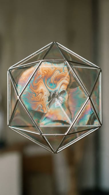 Soap film stretched across a wire frame, swirling interference colors before it pops