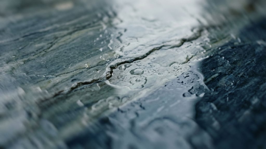 Wet marble surface with water pooling in natural veins and cracks, overhead view (lkiod0b5)