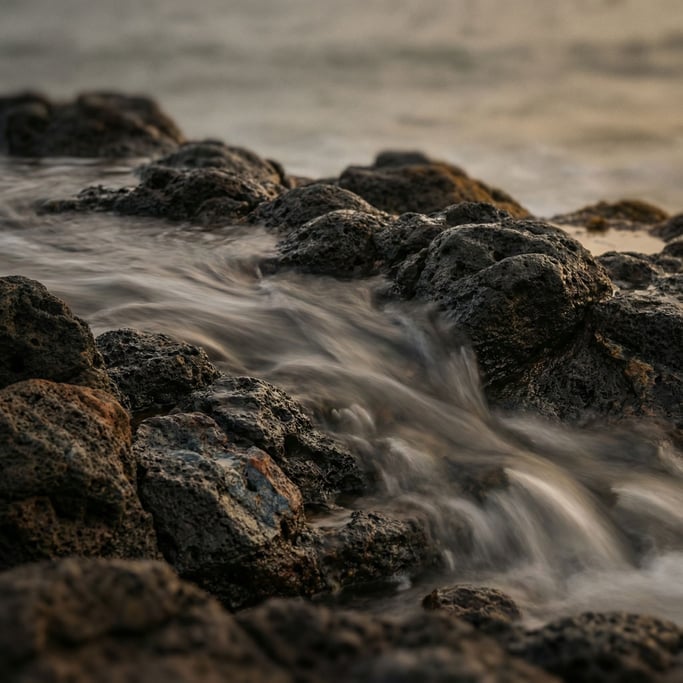 Ocean waves over black volcanic rock, long exposure turning water to silk (lmbmv138)