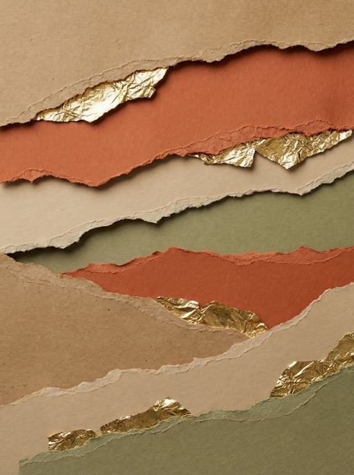 Kraft brown and terracotta and sand and olive green — torn paper pieces with ragged edges stacked in