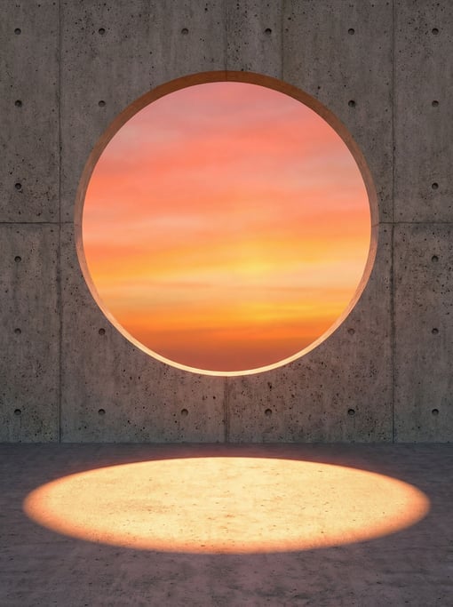 Raw concrete meets sunset sky — a brutal concrete wall with a single large circle cut clean through it