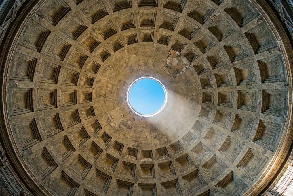 The interior of a massive concrete dome photographed looking straight up