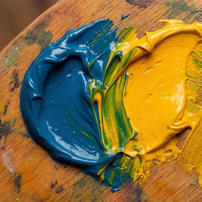 Cerulean blue folding into cadmium yellow on a palette — extreme close-up where streaks of vivid green emerge at the boundary