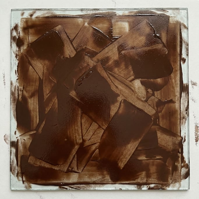 Wet ink on a glass plate — brayer rolled in different directions creating overlapping fields of texture in an abstract monoprint