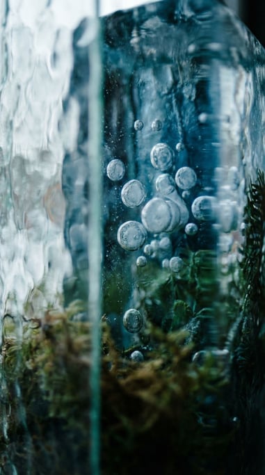 Frozen air bubbles trapped in clear blue ice, macro shot, cool crystalline tones (5redmj0o)