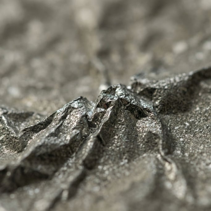 Crumpled metallic foil catching soft directional light, tiny mountains of micro-reflections (8l2nrwl5)