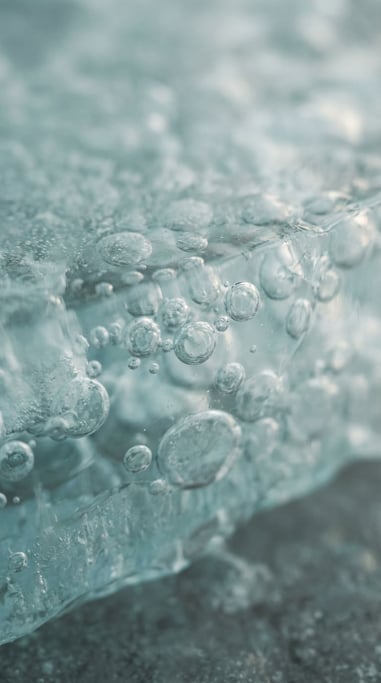 Frozen air bubbles trapped in clear blue ice, macro shot, cool crystalline tones (ryid5yyb)