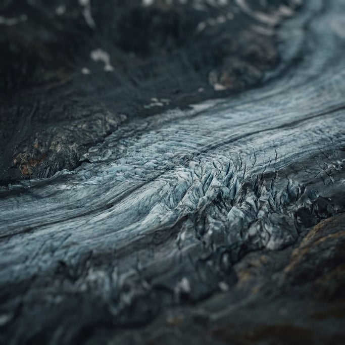Aerial view of a glacier, crevasses and blue-white ice fields, abstract patterns from above (tpgtk2lc)