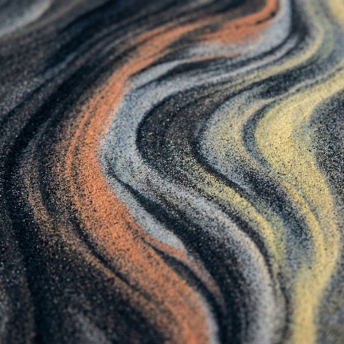 Sand dunes seen from above, abstract curves and soft shadows in cool morning light (v8czhyss)