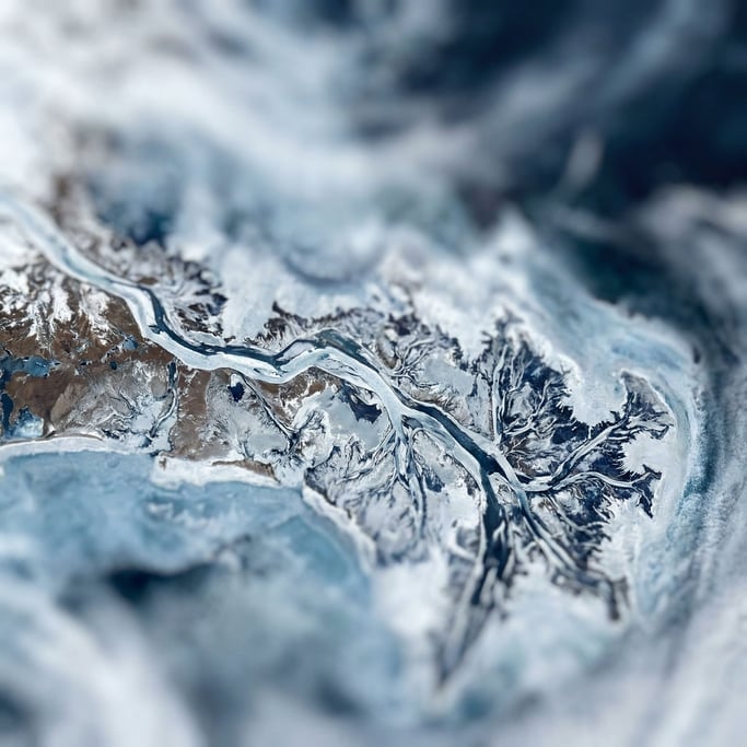Satellite view of river deltas branching into the sea, fractal patterns in blue and brown (x65gmqgj)