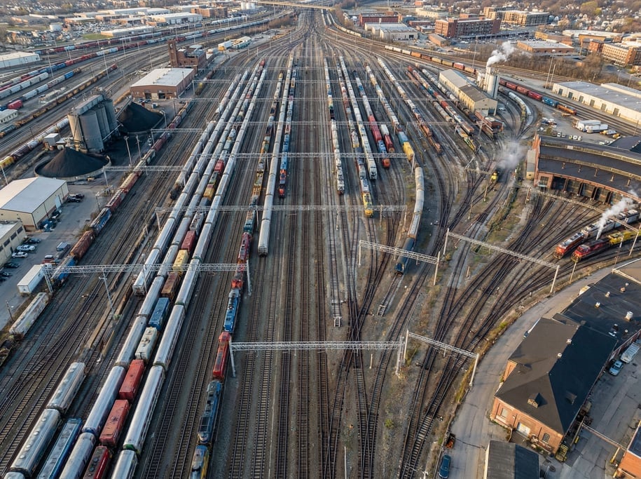Aerial view of a train station rail yard with dozens of parallel tracks converging and diverging