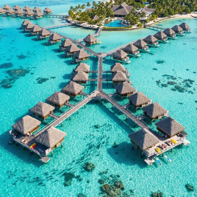 Overhead shot of overwater bungalows in a tropical resort