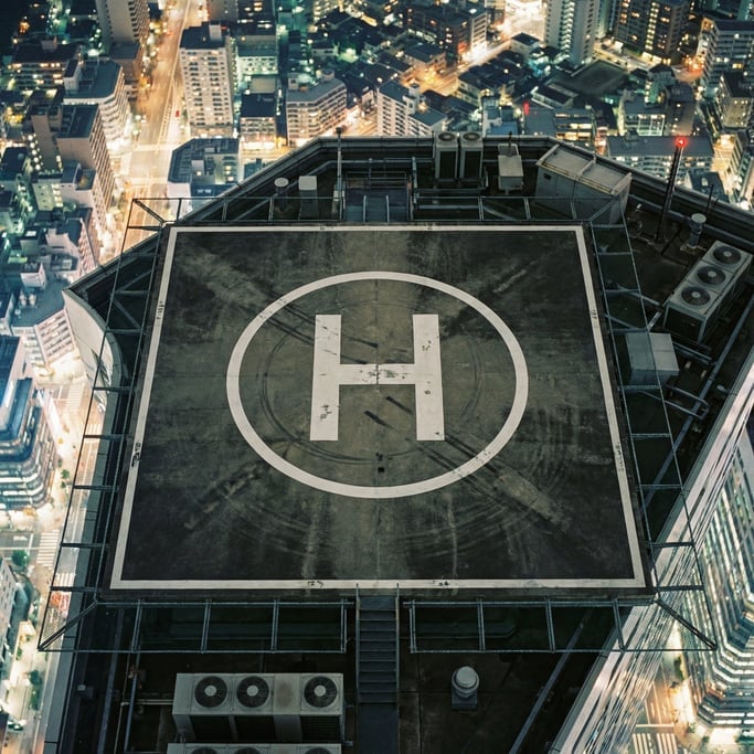 Overhead shot of a helipad on a skyscraper rooftop