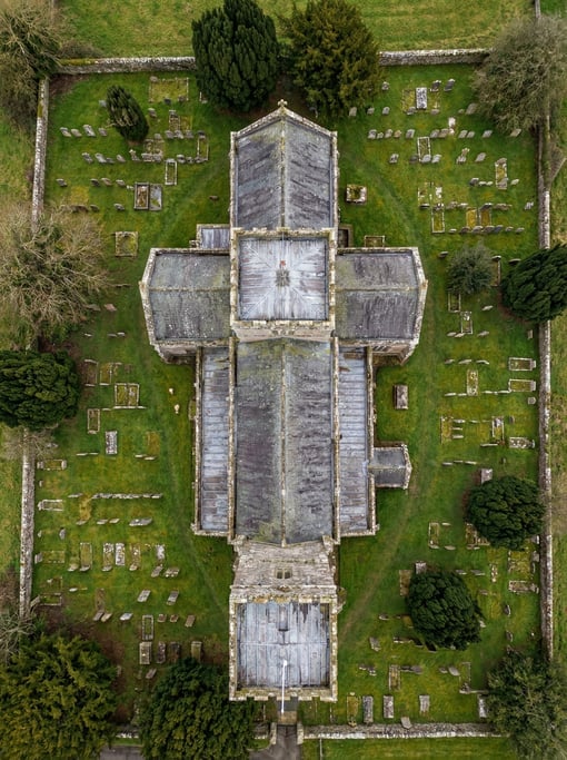 Top-down shot of a church from directly above showing the cruciform floor plan in stone