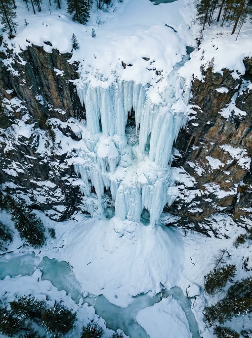 Overhead aerial of a frozen waterfall on a cliff face