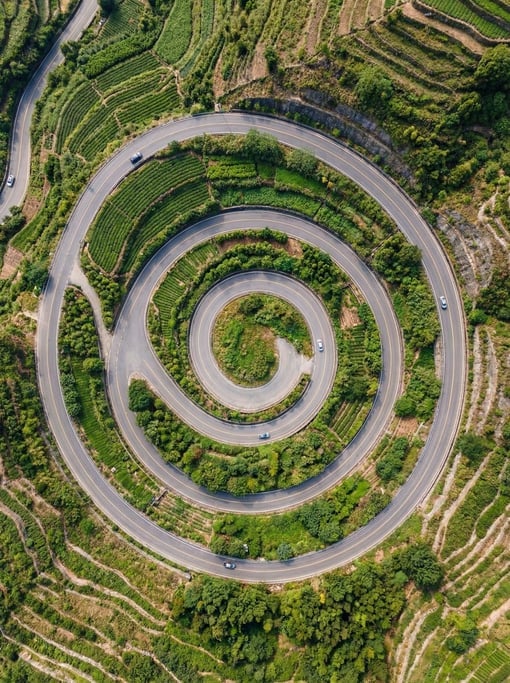 Top-down view of a spiral road descending a hillside