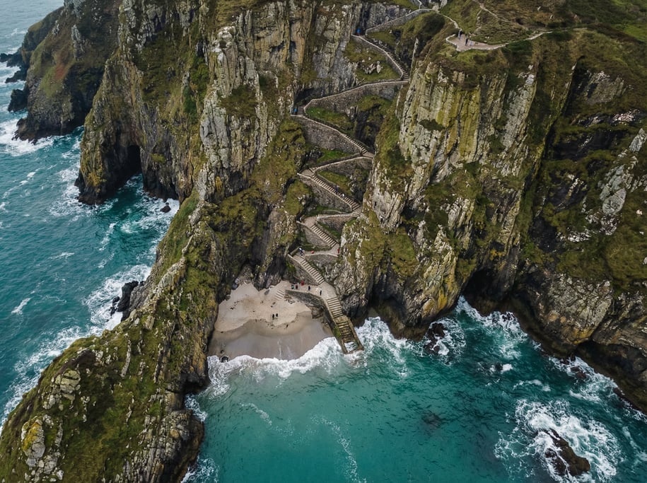 Drone view of a winding coastal staircase carved into a cliff face