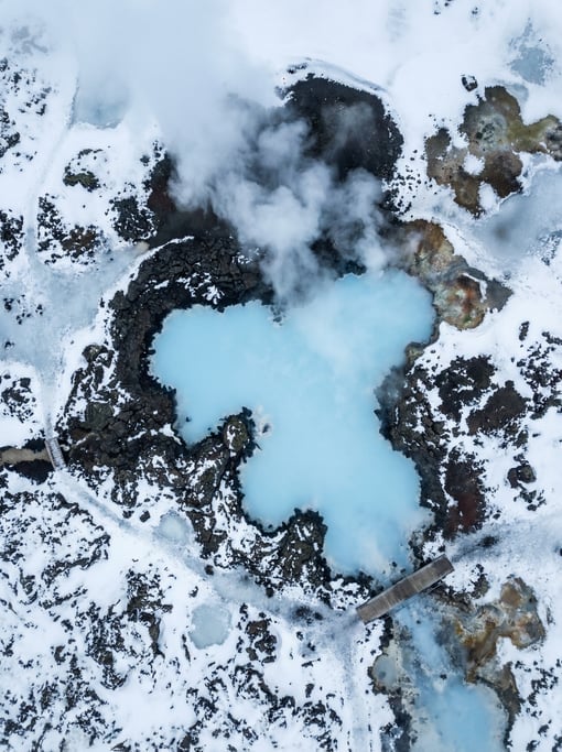 Top-down drone shot of a natural hot spring pool in Iceland