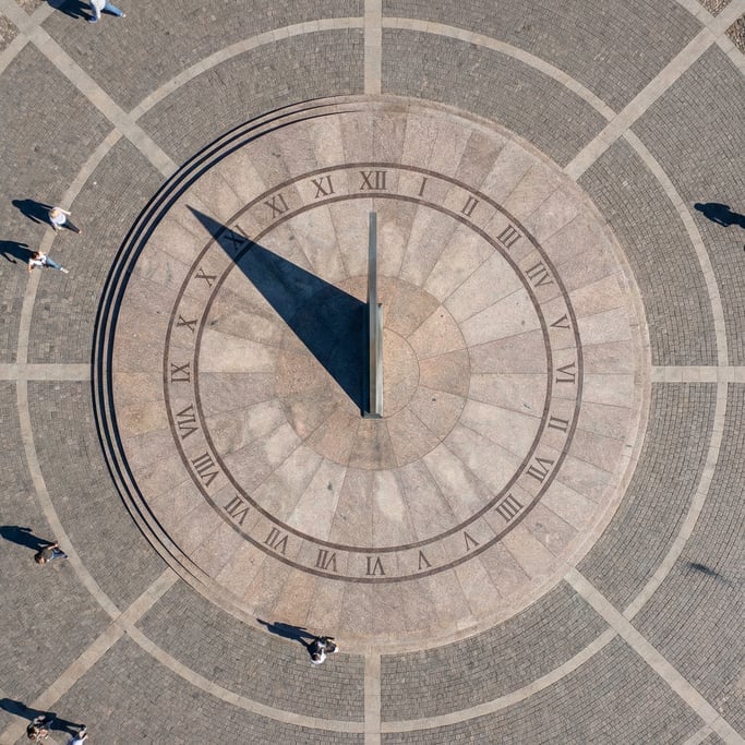 Overhead shot of a large sundial on a public plaza from above