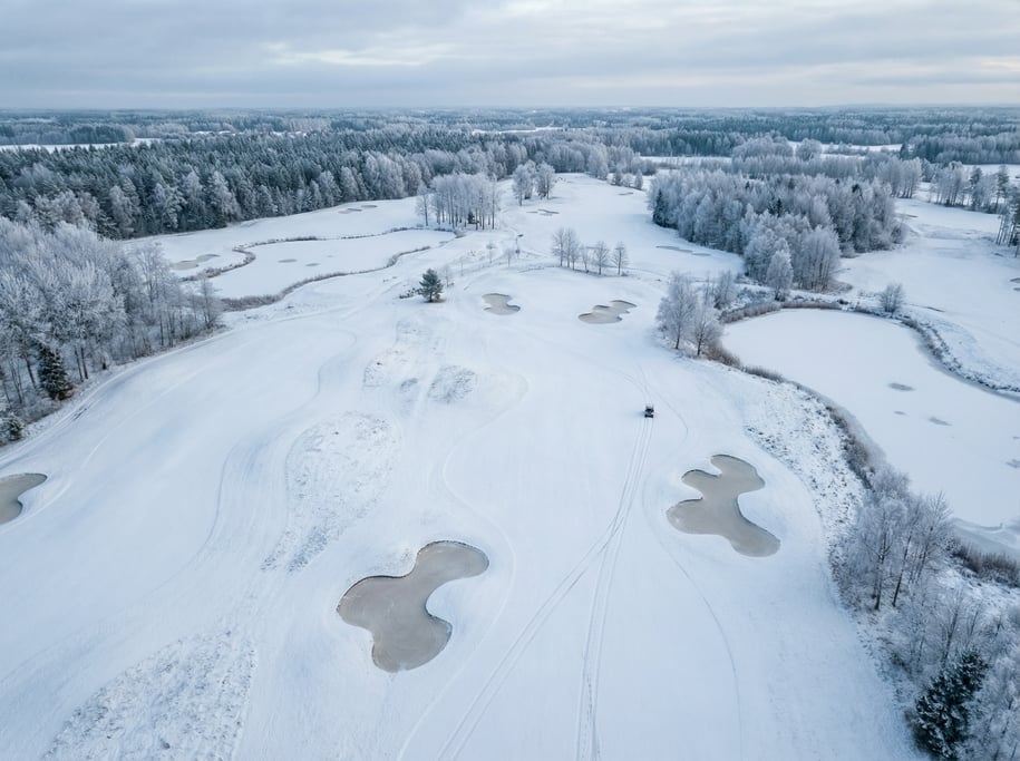 Drone view of a snow-covered golf course in winter