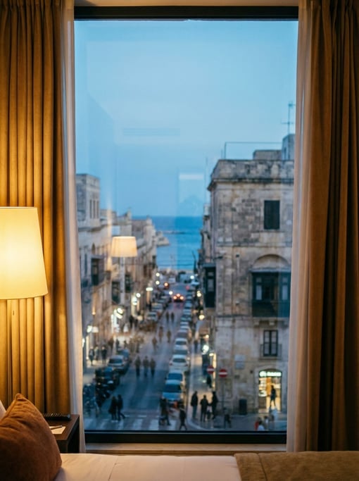 Looking out through a hotel room window on a high floor at a Mediterranean city street