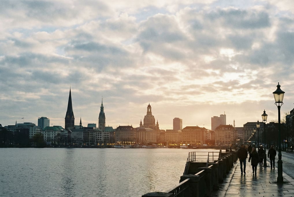 Distant city skyline seen from a lakeside promenade