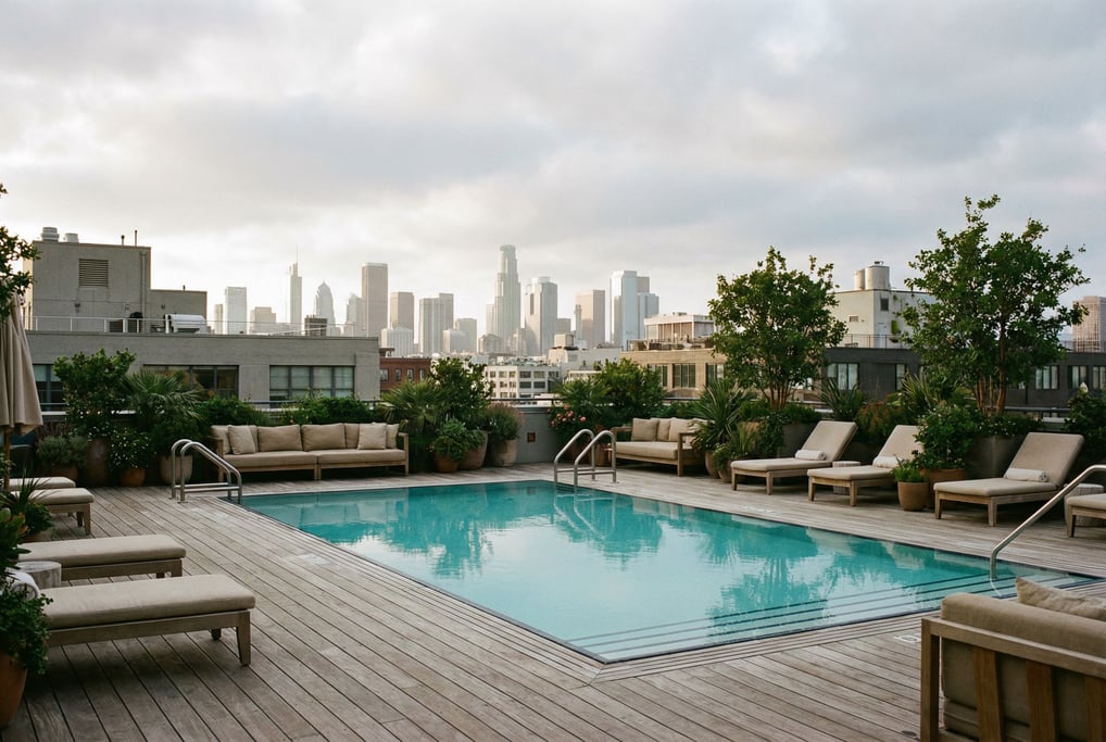 Rooftop pool deck overlooking downtown at cloudy afternoon, wooden decking and comfortable seating