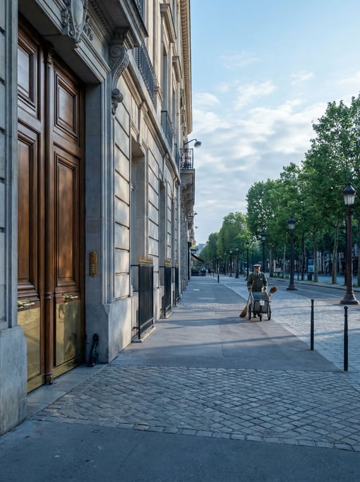 Grand Neoclassical boulevard with grand double doors with brass hardware at street level