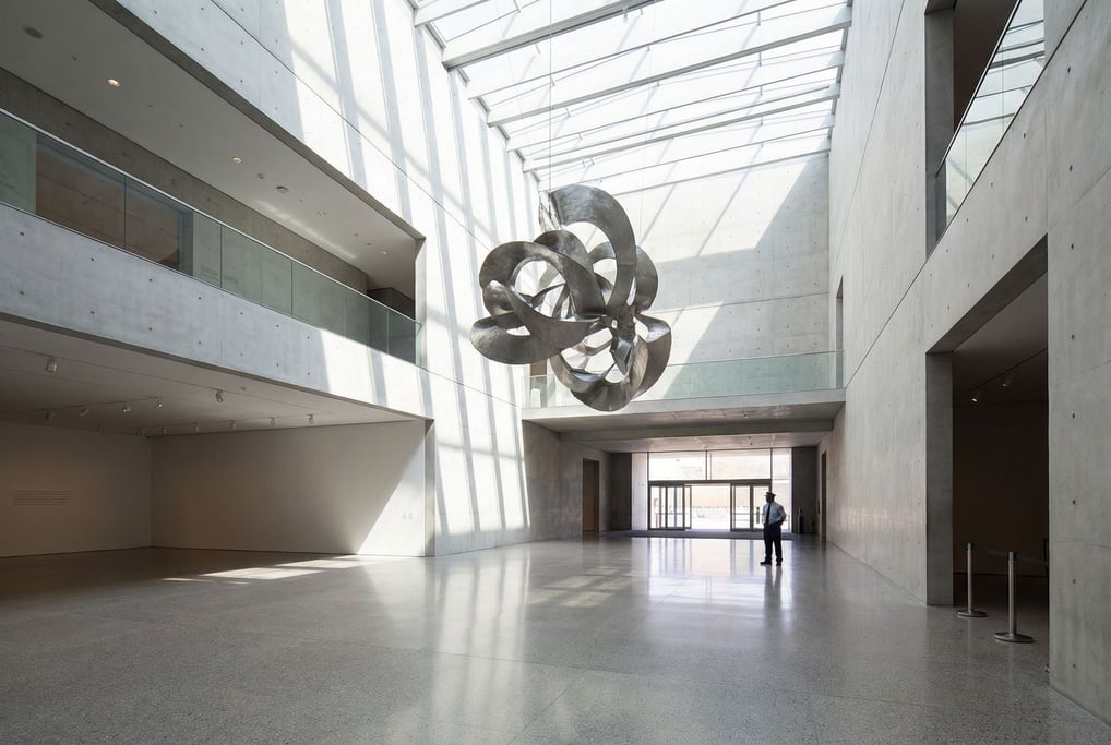 Double-height lobby with monumental art inside a modern art museum