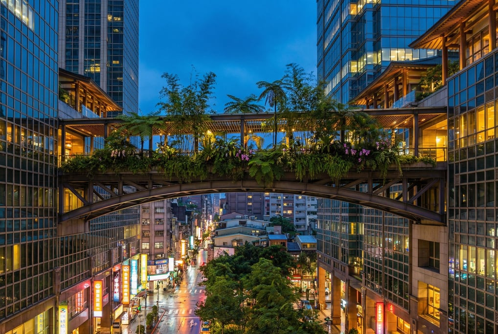 Elevated walkway between glass towers in a Taipei