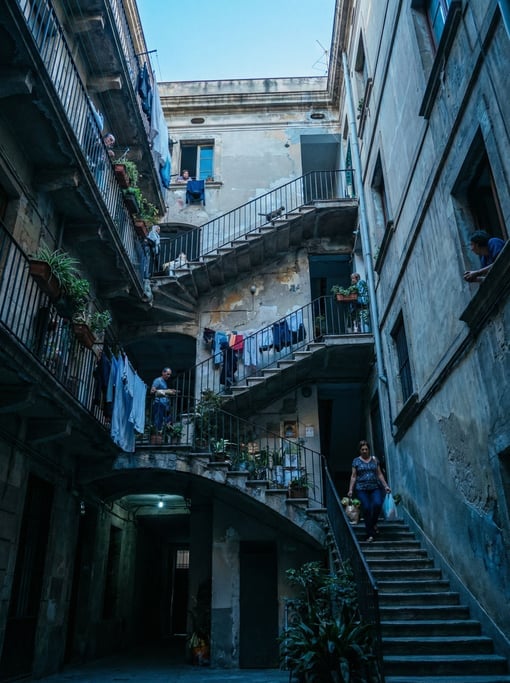 Looking up through a courtyard of a tall residential building