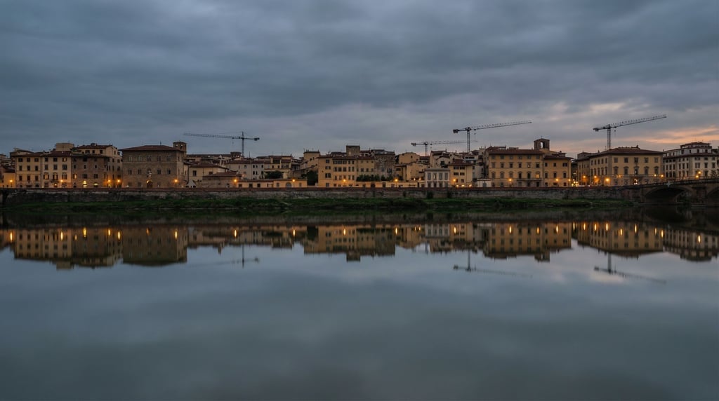 Mediterranean low-rise city skyline reflected in a calm river at dusk