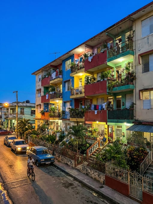 Social housing block with colorful balconies in a tropical neighborhood