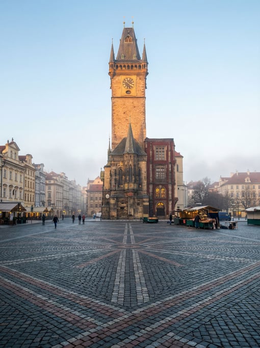 Market square with a historic clock tower in a European city