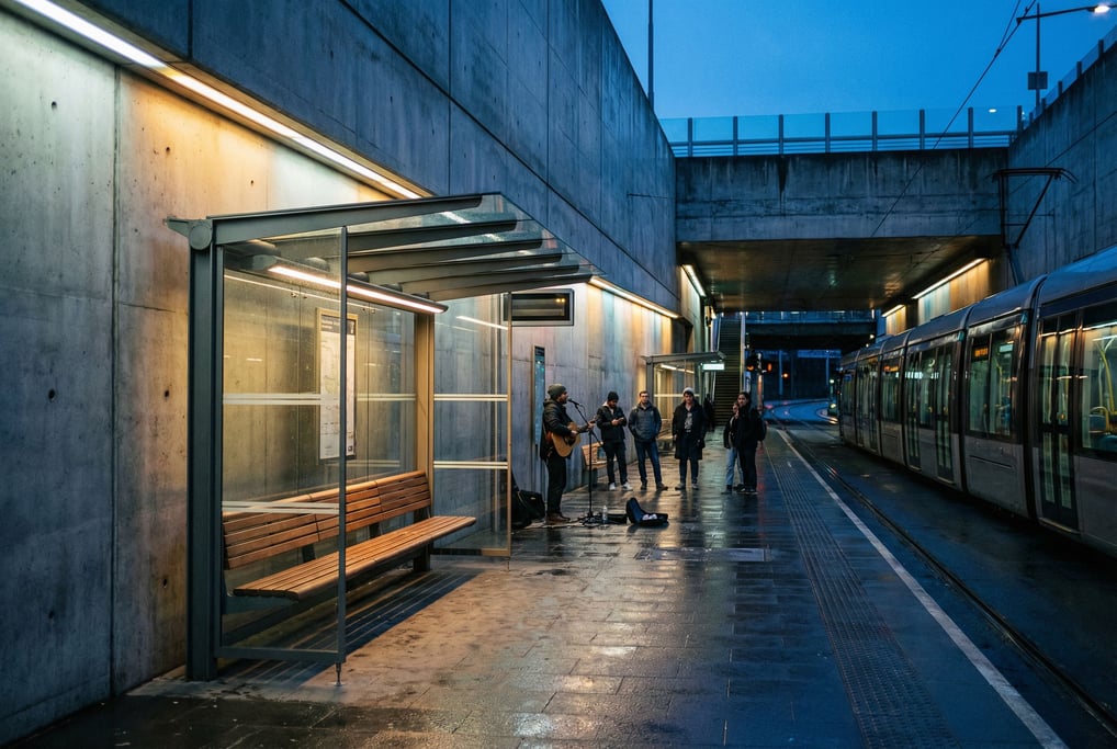 Modern tram stop with glass shelter, polished concrete walls and dramatic recessed lighting