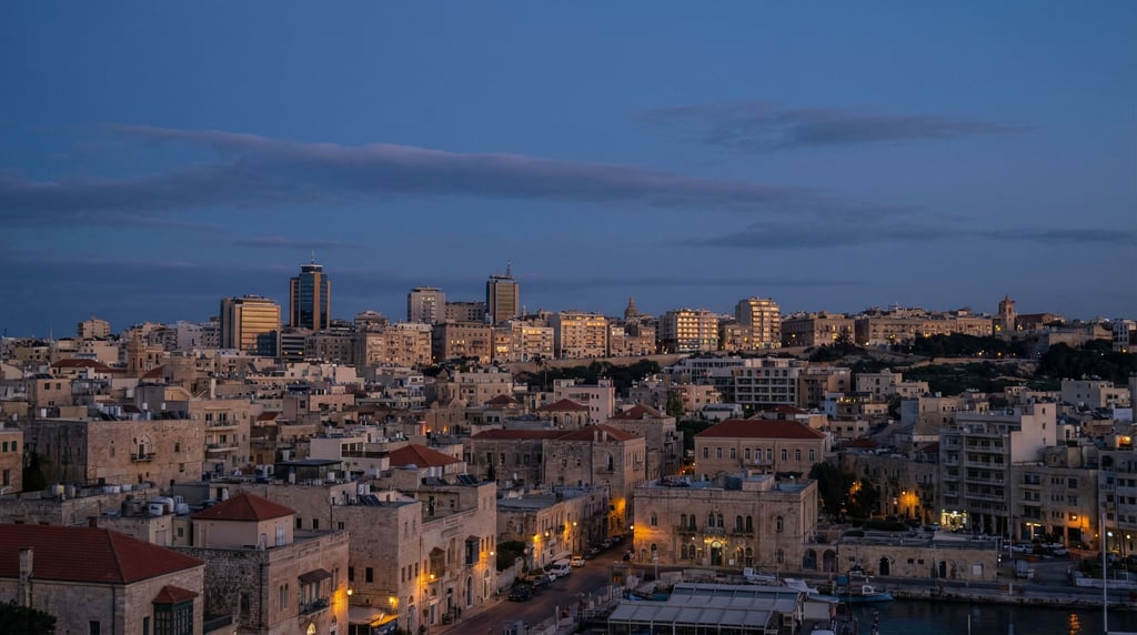 Sweeping panoramic view of a Mediterranean low-rise city skyline at dusk