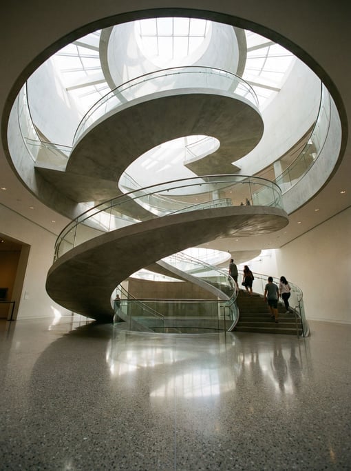 Spiral staircase seen from below inside a modern art museum