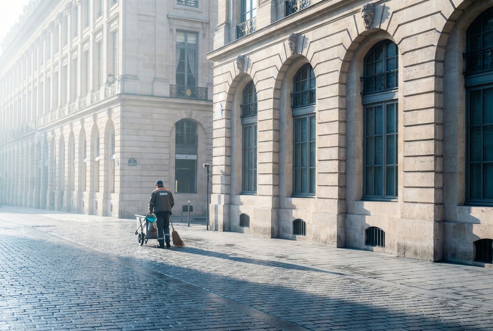 Grand Baroque boulevard with tall arched windows with decorative keystones, early morning