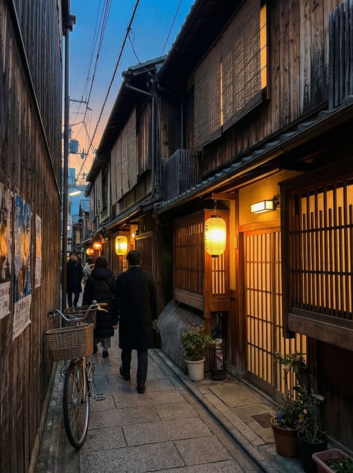Narrow Kyoto wooden machiya street with paper lanterns glowing warmly above doorways, dawn