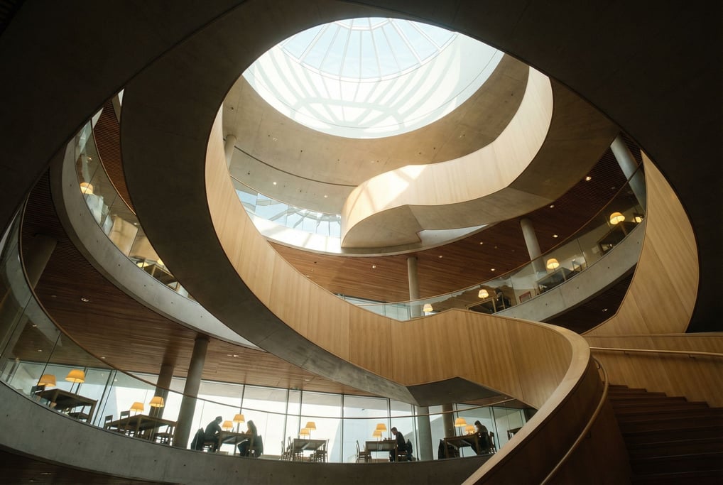 Spiral staircase seen from below inside a modern art museum