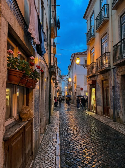 Narrow Lisbon tiled backstreet with cobblestones wet from recent rain reflecting warm light
