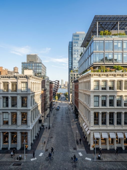 Wide-angle photograph of a SoHo cobblestone street with designer storefronts in New York City on a b