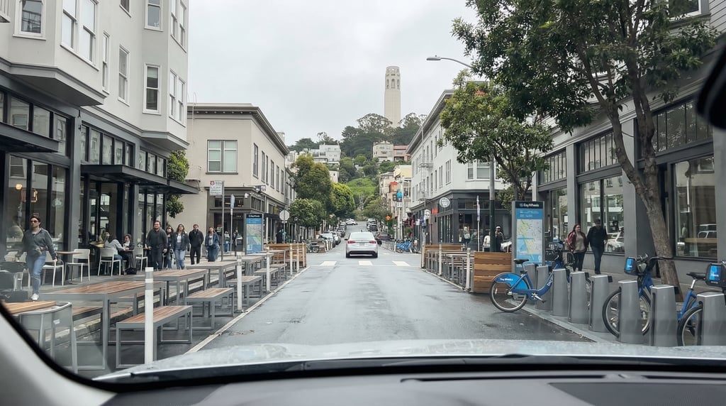 First-person perspective driving through Valencia Street with modern cafés and bike-share stations i