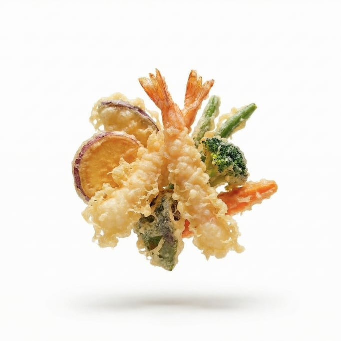 Tempura shrimp and vegetables in light crispy batter, floating in mid-air