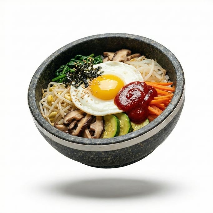 A bowl of bibimbap with colorful vegetables, egg, and gochujang